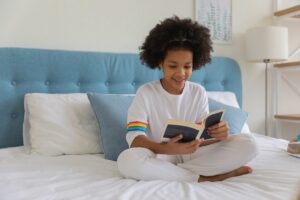 Young black girl reading a book